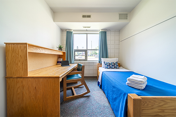 Single bed and desk in Semi-Private Accommodations.